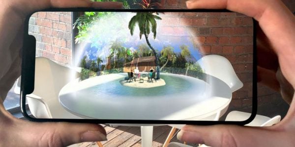 Hands holding a smartphone showing a virtual reality image