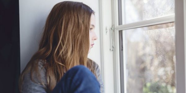 A girl looks out of a window