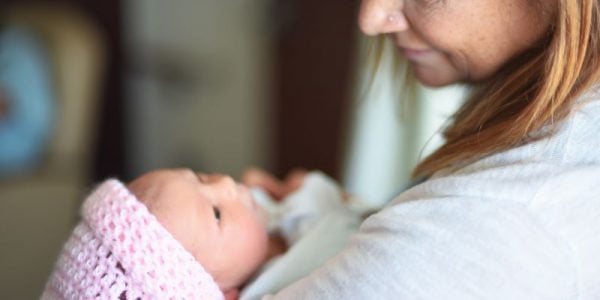 A woman holding a baby
